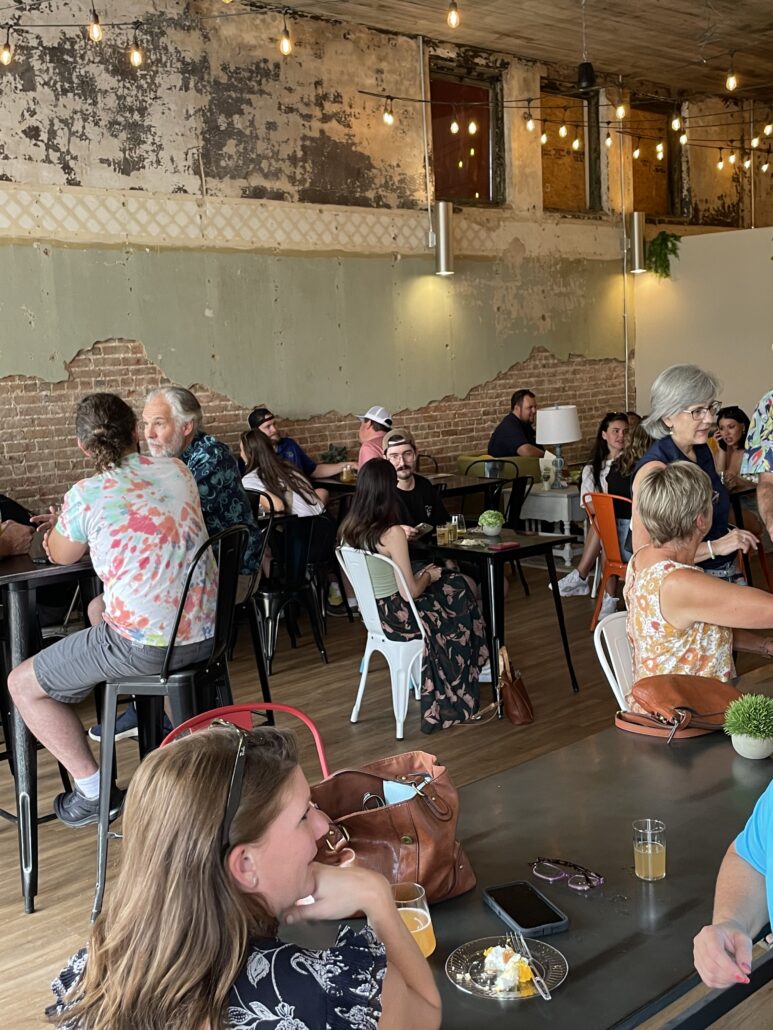 Happy customers sitting inside and enjoying drinks at local ties.